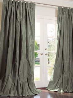 a pair of curtains hanging in front of a door