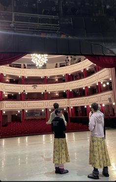 two people standing in front of an empty stage