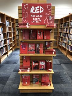 there are many books on the shelves in the library and one is red with white hearts