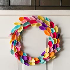 a wreath made out of felt sitting on top of a white door frame next to a wall