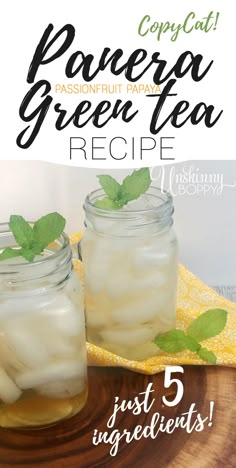 two mason jars filled with green tea on top of a wooden table