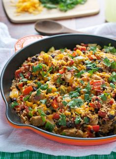 a pan filled with rice and vegetables on top of a table