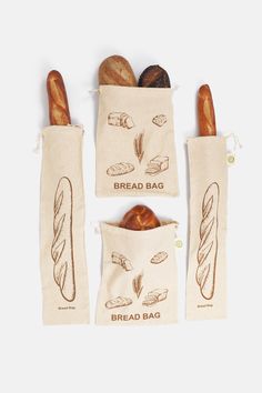 three bags with breads in them sitting next to each other