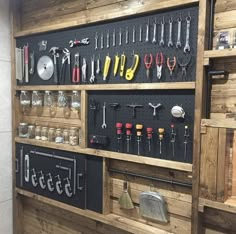 the wall is filled with many different tools and wrenches on it's shelves