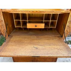 an old wooden desk with drawers and shelves