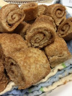 some cinnamon rolls are sitting on a towel