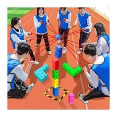 a group of young people playing with blocks on an outdoor court, surrounded by arrows