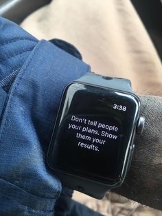 a person wearing a smart watch with a message on the screen that reads, don't tell people your plan show them your results