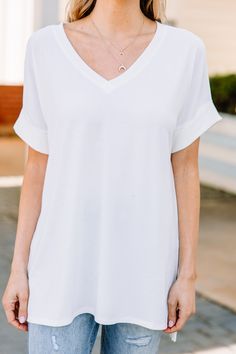 This versatile v-neck tee is here to make your life easy! It's honestly the perfect top for year round styling and layering. You can knot the hem or half tuck into your favorite jeans or shorts. You can layer it with all sorts of jackets, shackets, or kimonos. And don't even get us started on accessories! The options are absolutely endless! This top is truly a staple piece! This top features a v neckline, short cuffed sleeves, and a generous fit. Material has generous amount of stretch. Cam is w Versatile V-neck Tops For Brunch, White V-neck T-shirt For Everyday, White Relaxed Fit V-neck Top, Chic White V-neck T-shirt, White Short Sleeve V-neck Top For Everyday, White V-neck Short Sleeve Top, White V-neck T-shirt For Day Out, White V-neck Top For Brunch, Relaxed Fit V-neck Tops For Brunch