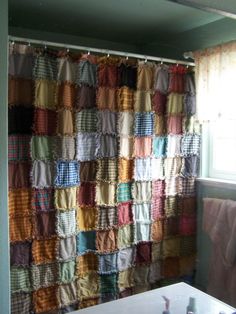 a bathroom with a shower curtain made out of squares