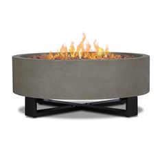 an outdoor fire pit is shown with flames coming out of the top and on it's sides