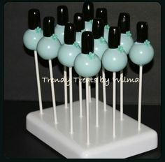 there are many black and white lollipops on the stick with green bows