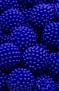 many blue balls are stacked on top of each other in the same pattern as one another