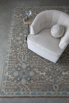 a white chair sitting on top of a rug