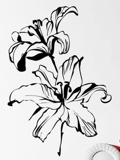 a black and white drawing of a flower on a wall next to a red vase