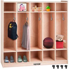 a child's wooden locker with shoes and backpacks