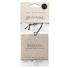 two packaged air fresheners in white packaging with black string on the front and back