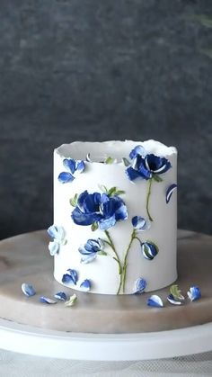 a white cake with blue flowers on it