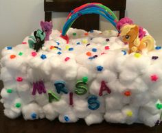 a cake made to look like a bag with pony ponies on it and the word msa is spelled in multicolored letters