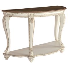 an antique white console table with wood top