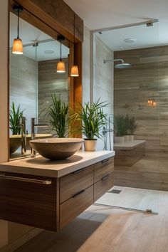 a bathroom with a sink, mirror and plants in the shower area on the counter