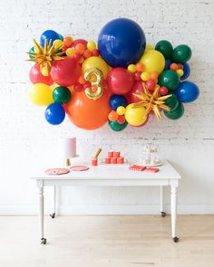 a table with balloons and decorations on it