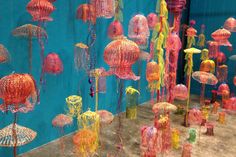 there are many jellyfish on display in the room with blue walls and flooring