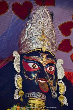 a close up of a mask with hearts in the background