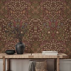 a wooden table sitting next to a wall with a vase on top of it and a plant