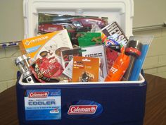 a cooler filled with assorted items on top of a wooden table