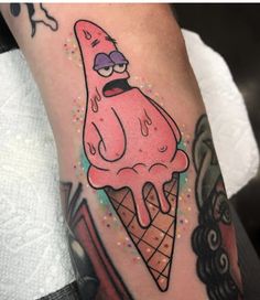 an ice cream cone with cartoon character on it's arm and some other things in the background