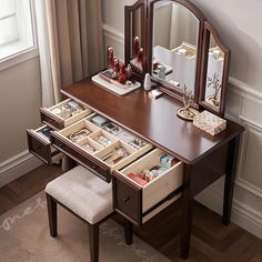 a dressing table with drawers and a mirror