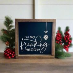 a chalkboard with the words i'm so freaking merry written on it next to christmas decorations