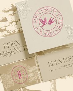 three business cards with different logos on them, one in pink and the other in white