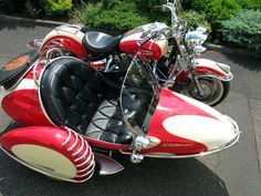 a red and white motorcycle parked on the street