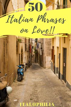 an alley way with scooter parked on the side and yellow sign that says 50 italian phrases on love