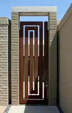 an entrance to a house with a wooden door and brick wall in the back ground