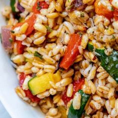 a white bowl filled with rice and vegetables