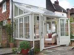 a white house with an enclosed patio and sitting area