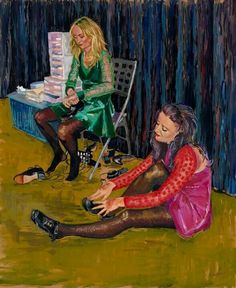 two women sitting on the ground in front of a painting