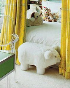 there is a stuffed animal on the floor in this bedroom with yellow curtains and drapes