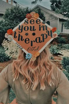 a woman wearing a graduation cap with the words see you in therapy written on it