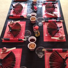 the table is set with red and black napkins