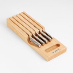 four stainless steel brushes in a wooden holder