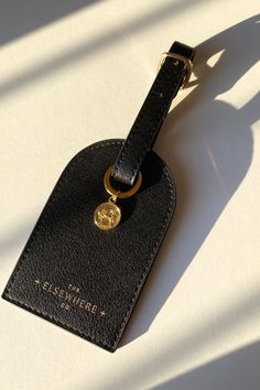 A luxe leather luggage tag for your next adventure. This customisable luggage tag in Nightfall Black comes with a gold keyring clip personalised with a complimentary 18k gold plated initial charm. Stack and style multiple charms from our mix n' match collection. Remove the gold clip when you're not travelling and use as a stylish keyring! Consciously crafted from recycled leather.  *Select your complimentary initial charm. Occasionally clean your luggage tag with a soft dry cloth and store in its protective dust bag. Treat your charms gently and avoid contact with lotions, sunscreens or perfumes. Essentials Brand, Black Luggage, Match Collection, Packing Jewelry, Leather Passport Cover, August Birthstone Jewelry, July Birthstone Jewelry