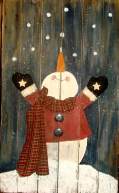 a snowman is painted on a wooden board