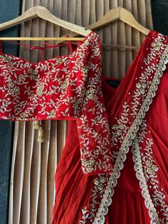 A two-piece red pre-stitched saree set from the Priti Sahni collection. This gorgeous red georgette pre-stitched ruffled saree with pearl and zardozi rose gold hand embroidery and scalloped edging is paired with a red net embroidered tie-up blouse. Red Dori Work Pre-draped Saree, Red Pre-draped Saree With Dori Work, Red Anarkali Pre-draped Saree For Eid, Fitted Red Pre-draped Saree For Eid, Traditional Embellished Pre-draped Georgette Saree, Designer Red Pre-draped Saree For Diwali, Red Pre-draped Designer Saree For Diwali, Elegant Red Embellished Pre-draped Saree, Elegant Red Pre-draped Saree For Festive Occasions