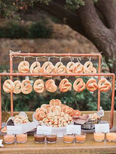 a table topped with lots of doughnuts and other food on top of it