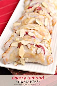 a white plate topped with almond covered pastry