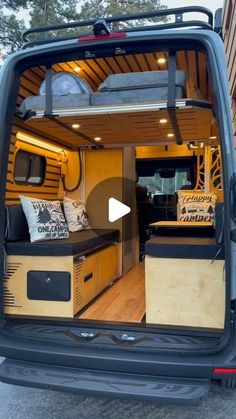 the interior of a van with its doors open and pillows on it's back